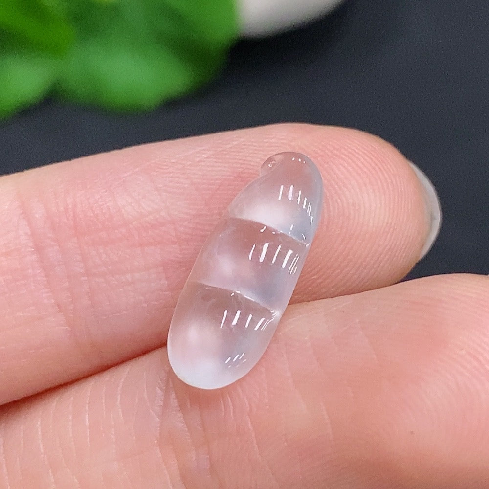HUILIU HQ jadeite blessing bean pendant featuring smooth green jade with carved details, hanging on a silk cord.