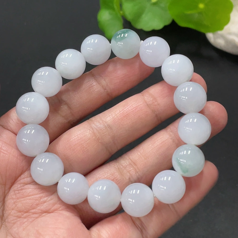 Huiliu Certified Jadeite bracelet featuring 12.4mm smooth, polished jade stones on a delicate string.