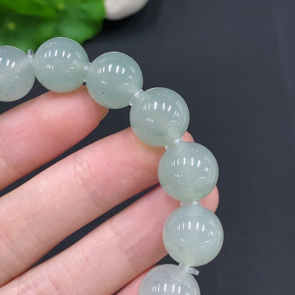 HUILIU HQ jadeite bracelet with 12.5mm beads, showcasing smooth, polished green jade stones on an elegant jewelry piece
