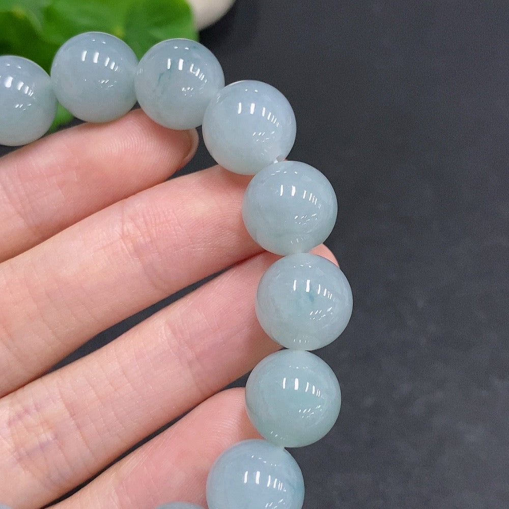 HUILIU HQ jadeite bracelet weighing approx. 52.1g with 12.3mm size, featuring smooth, polished jade stones on a natural string.