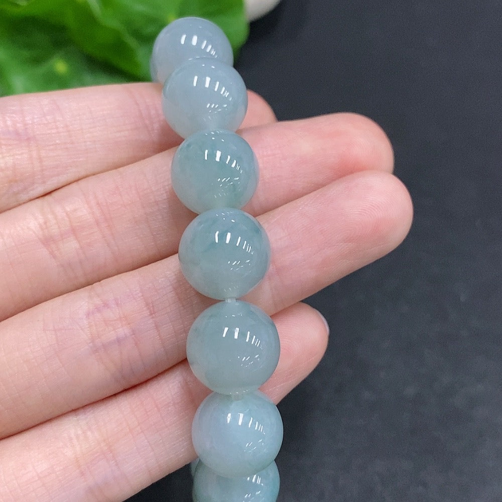 HUILIU HQ jadeite bracelet, approximately 52.1g, 12.3mm wide, featuring smooth, polished jade stones on a jewelry bracelet.