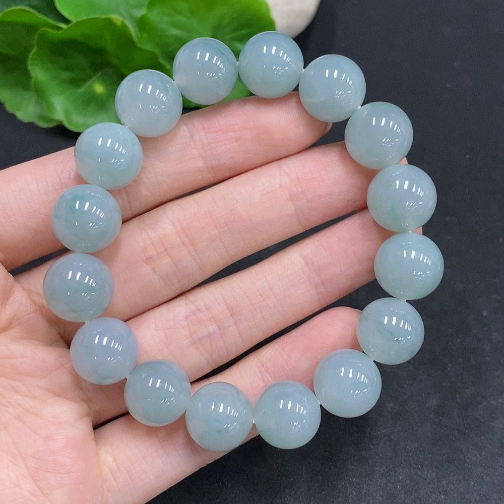 HUILIU HQ jadeite bracelet, approximately 52.1g, 12.3mm wide, showcasing smooth, polished jadeite beads.
