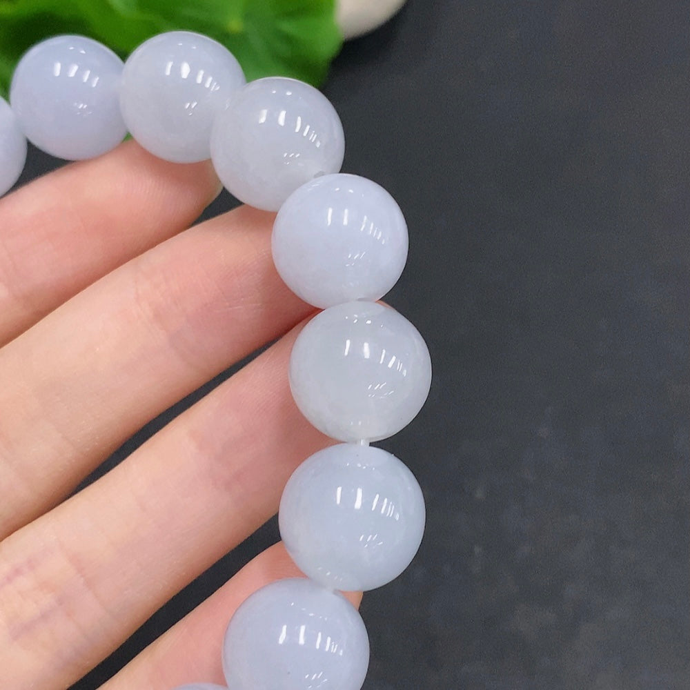 HUILIU HQ jadeite bracelet weighing 67.4g with 13.3mm beads, showcasing smooth, polished jade stones on a neutral background.
