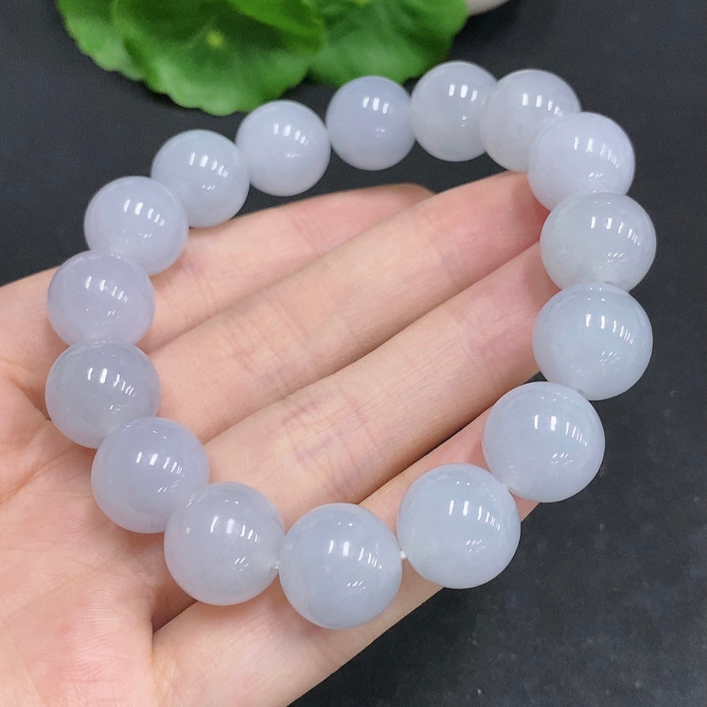 HUILIU HQ jadeite bracelet weighing 67.4g with 13.3mm beads, showcasing smooth, polished jade stones on a neutral background.