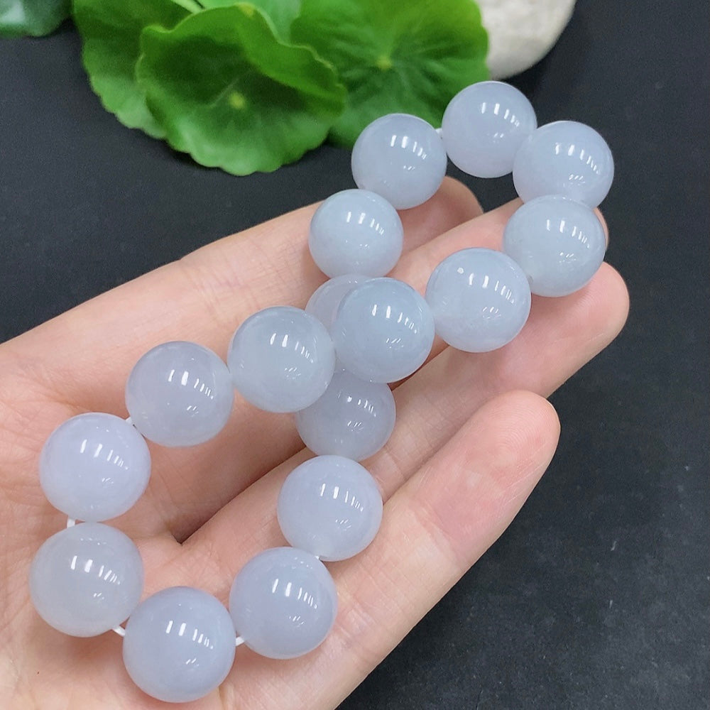 HUILIU HQ jadeite bracelet weighing approximately 67.4g with 13.3mm diameter, featuring smooth, polished jade stones on a flexible band.