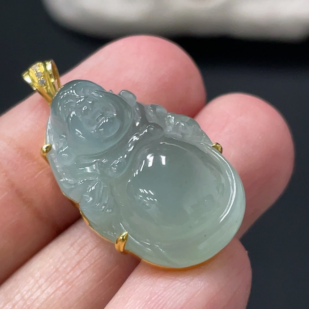 Jadeite Buddha pendant with 18k gold setting, shown in close-up, weighs approximately 6.04g, featuring intricate craftsmanship.