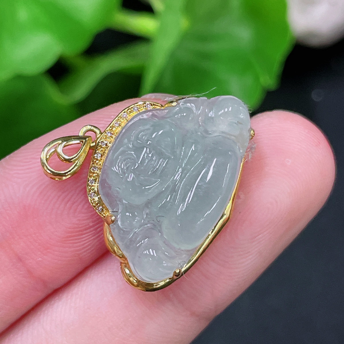 Huiliu HQ jadeite Buddha pendant with diamond accents, showcasing a polished green jade Buddha figure on a string.
