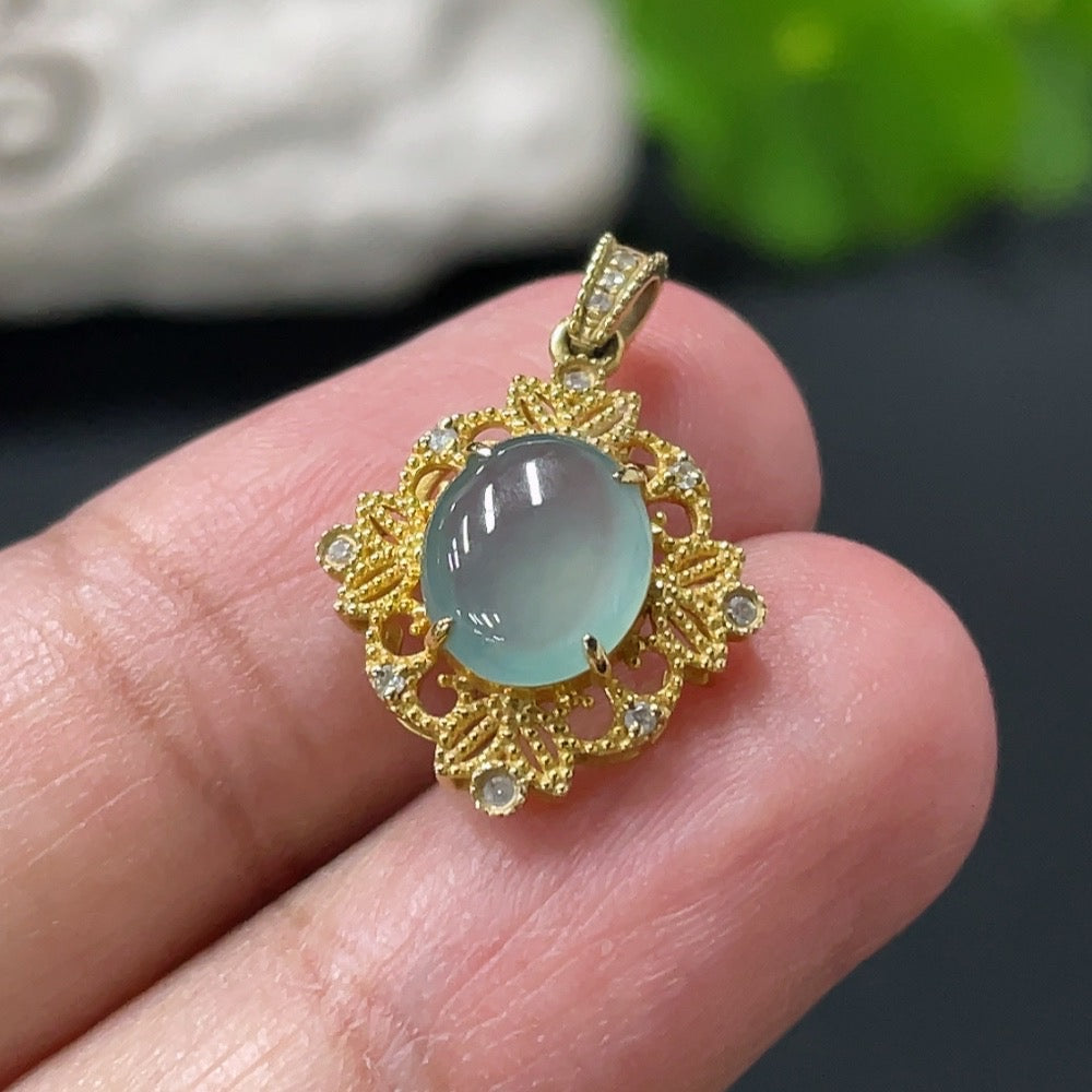 Jadeite cabochon pendant with 18K gold setting, showcasing a smooth, polished green jade stone in an elegant jewelry design.