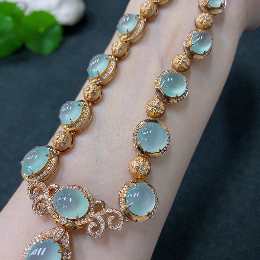 Jadeite cabochon necklace with 18K gold and diamond accents, featuring a polished jade stone, by HUILIU HQ.