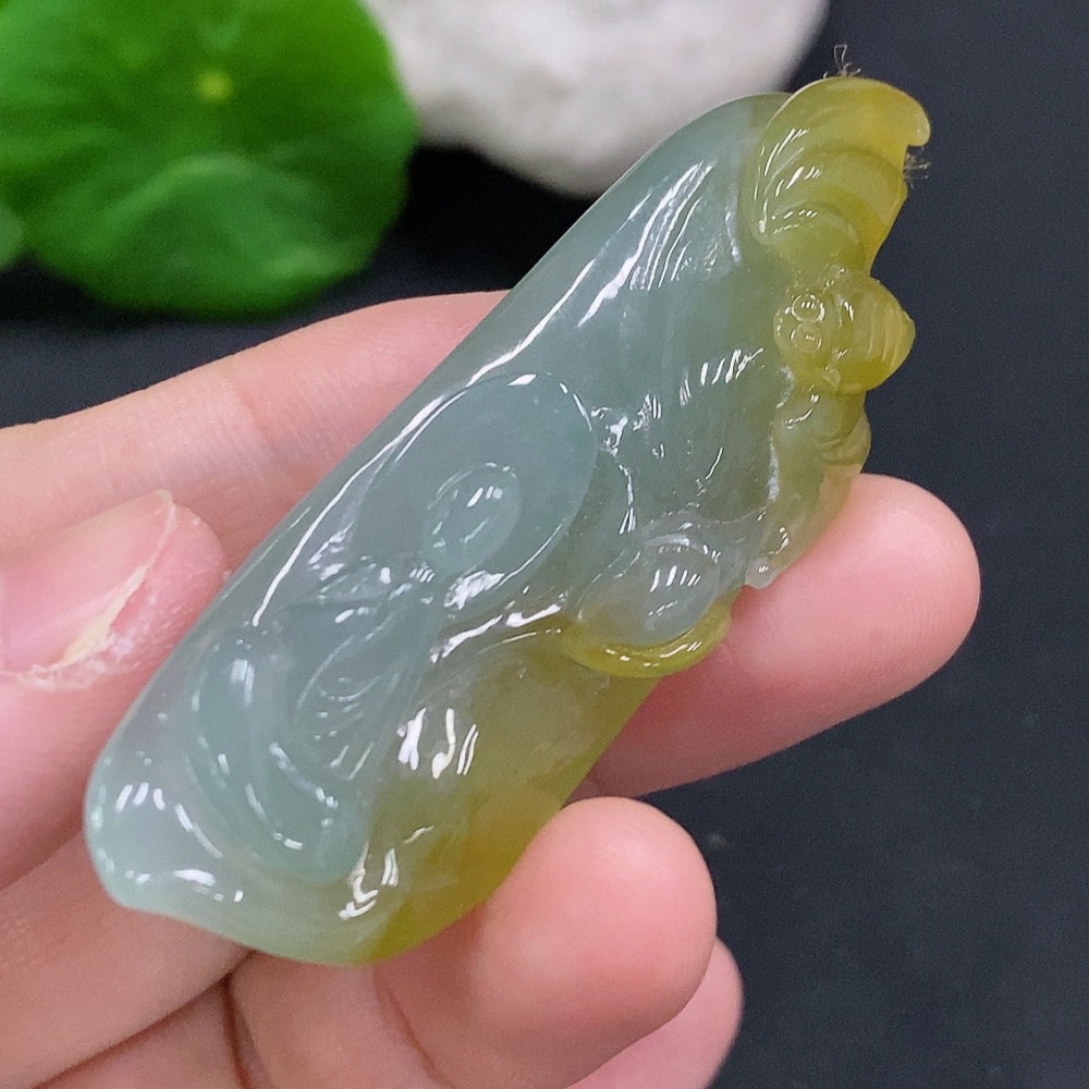 HUILIU HQ Jadeite Enlightenment Pendant featuring a smooth, polished jadeite jade pendant with intricate carvings, hanging on a silk cord.
