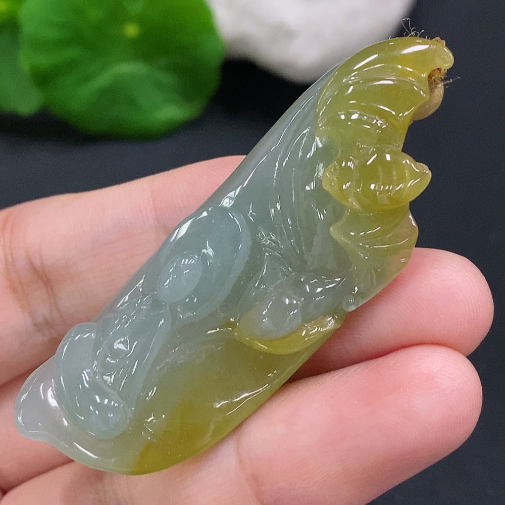 HUILIU HQ jadeite Enlightenment Pendant featuring a smooth, polished green jade stone with intricate carvings on a cord.