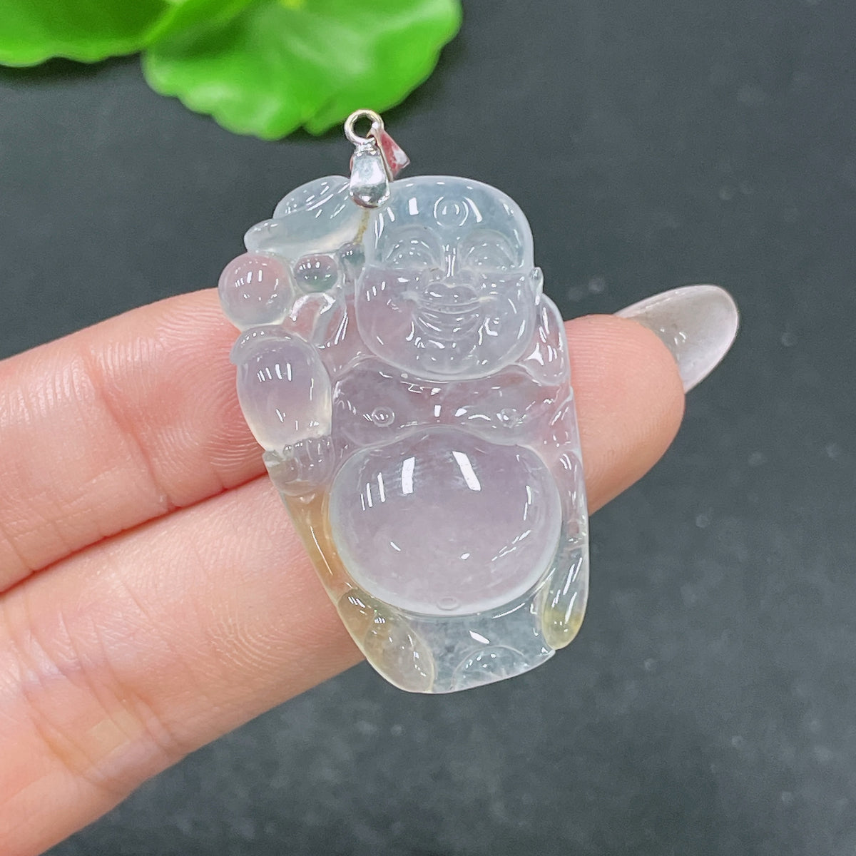 Jadeite Buddha pendant with 18k bezel by HUILIU HQ, showcasing a detailed carved jade Buddha on a white background.