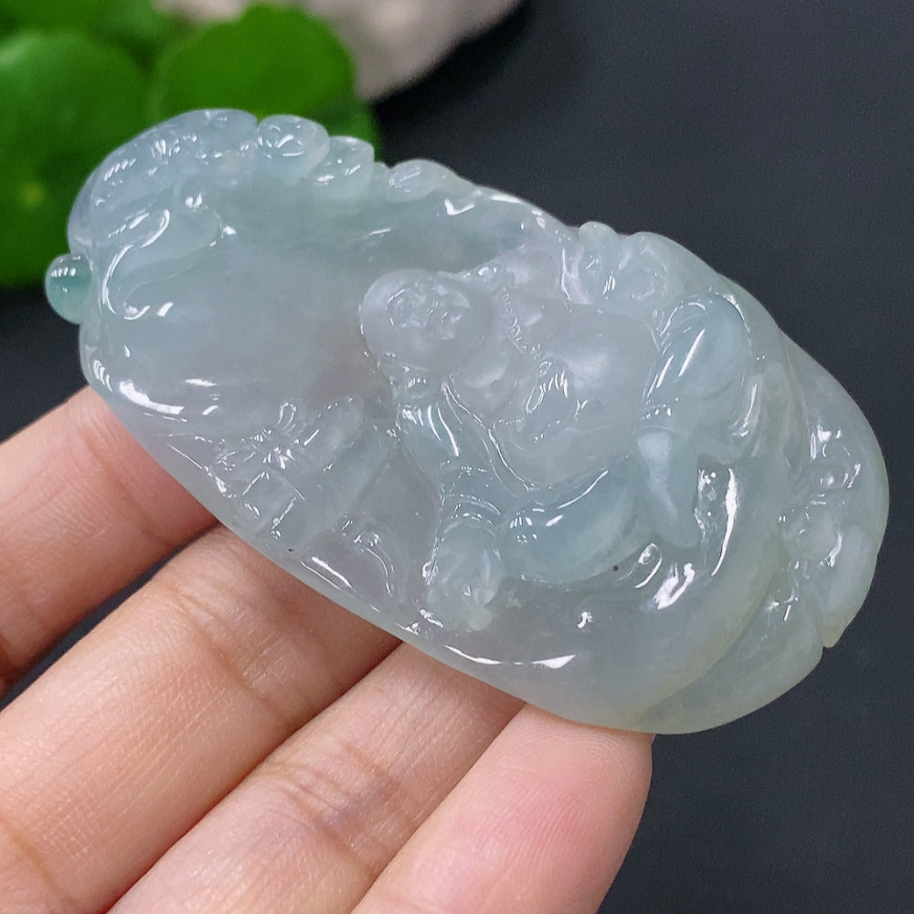 Jadeite Buddha pendant in green jade, crafted by HUILIU HQ, featuring a detailed Buddha figure on a polished jade surface.