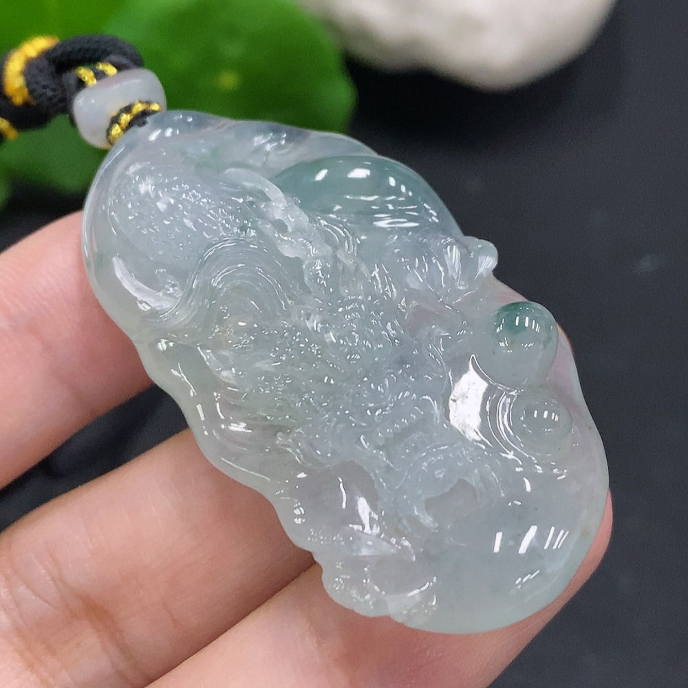 HUILIU HQ jadeite pendant featuring a carved dragon plaque with cord, weighing approximately 27.4g, showcasing intricate jade craftsmanship.