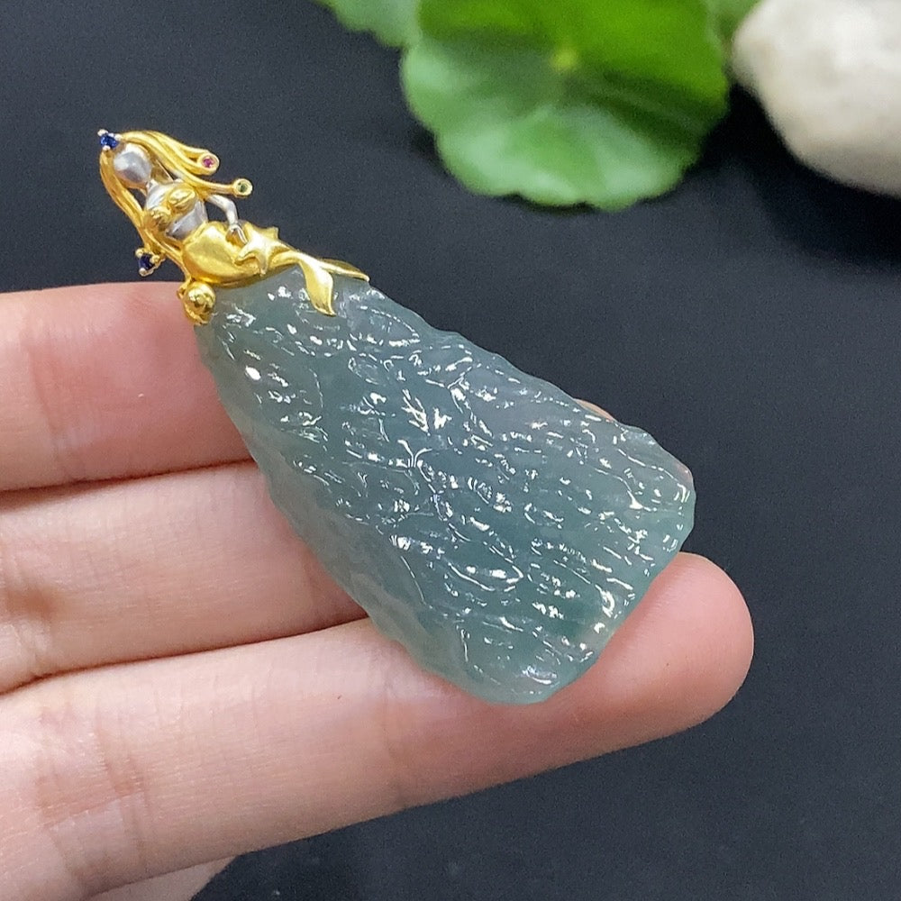 Huiliu Certified Jadeite pendant featuring smooth, polished green jade with natural variations and a sleek design.