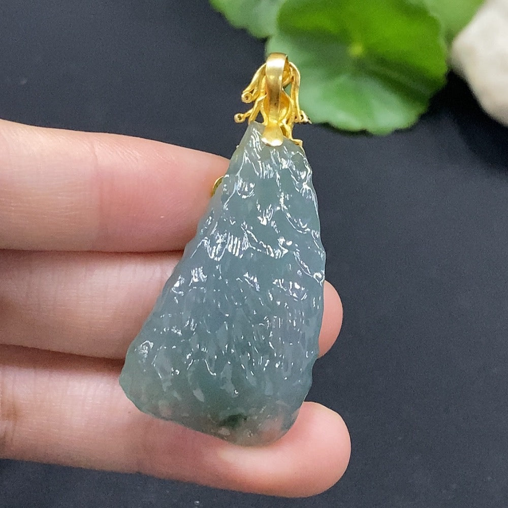 Huiliu Certified jadeite pendant featuring smooth, green jade with natural variations, showcasing elegant craftsmanship.
