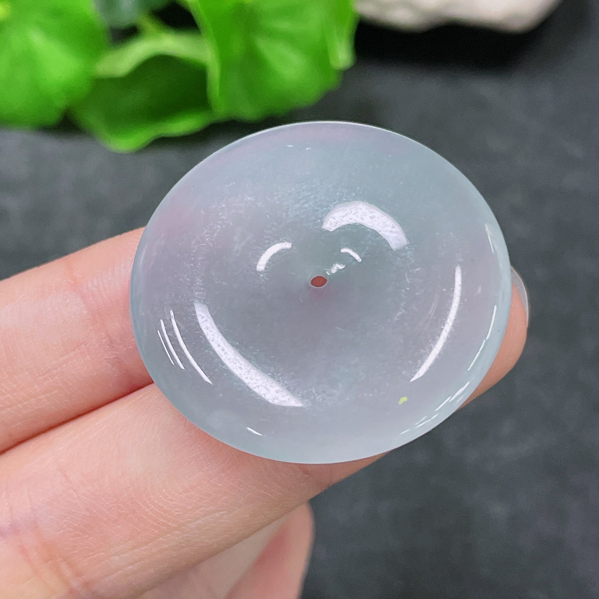 Huiliu Certified jadeite pendant featuring a peace buckle design, showcasing smooth green jade with intricate carved details.