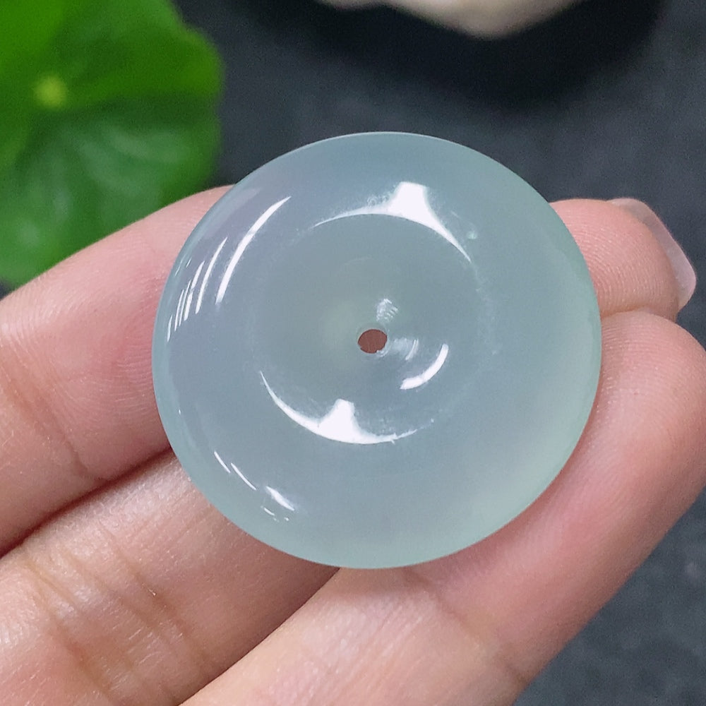 Huiliu HQ Jadeite Peace Ring Pendant featuring a carved jade design, certified by HUILIU HQ, showcasing a smooth, polished jade surface.
