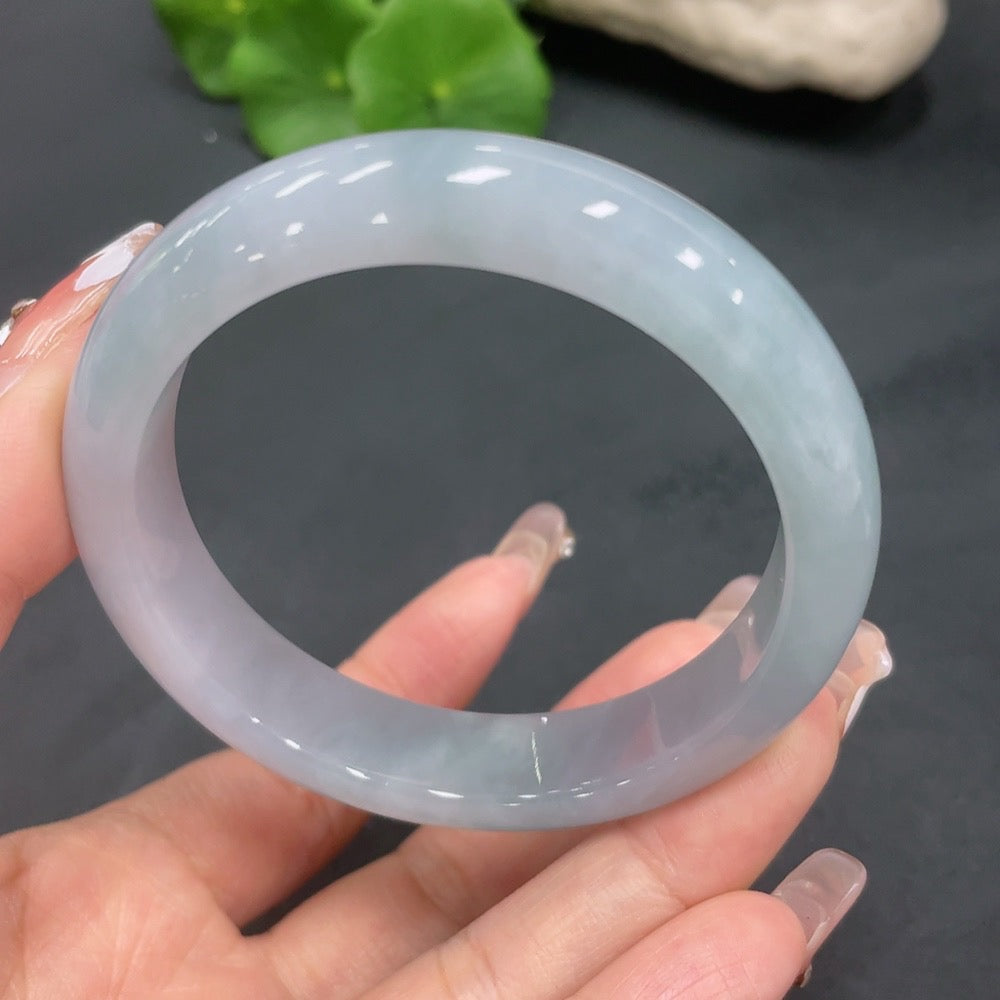 Huiliu Certified Jadeite Round Bangle showcasing smooth, polished green jade with a glossy finish and traditional round shape.
