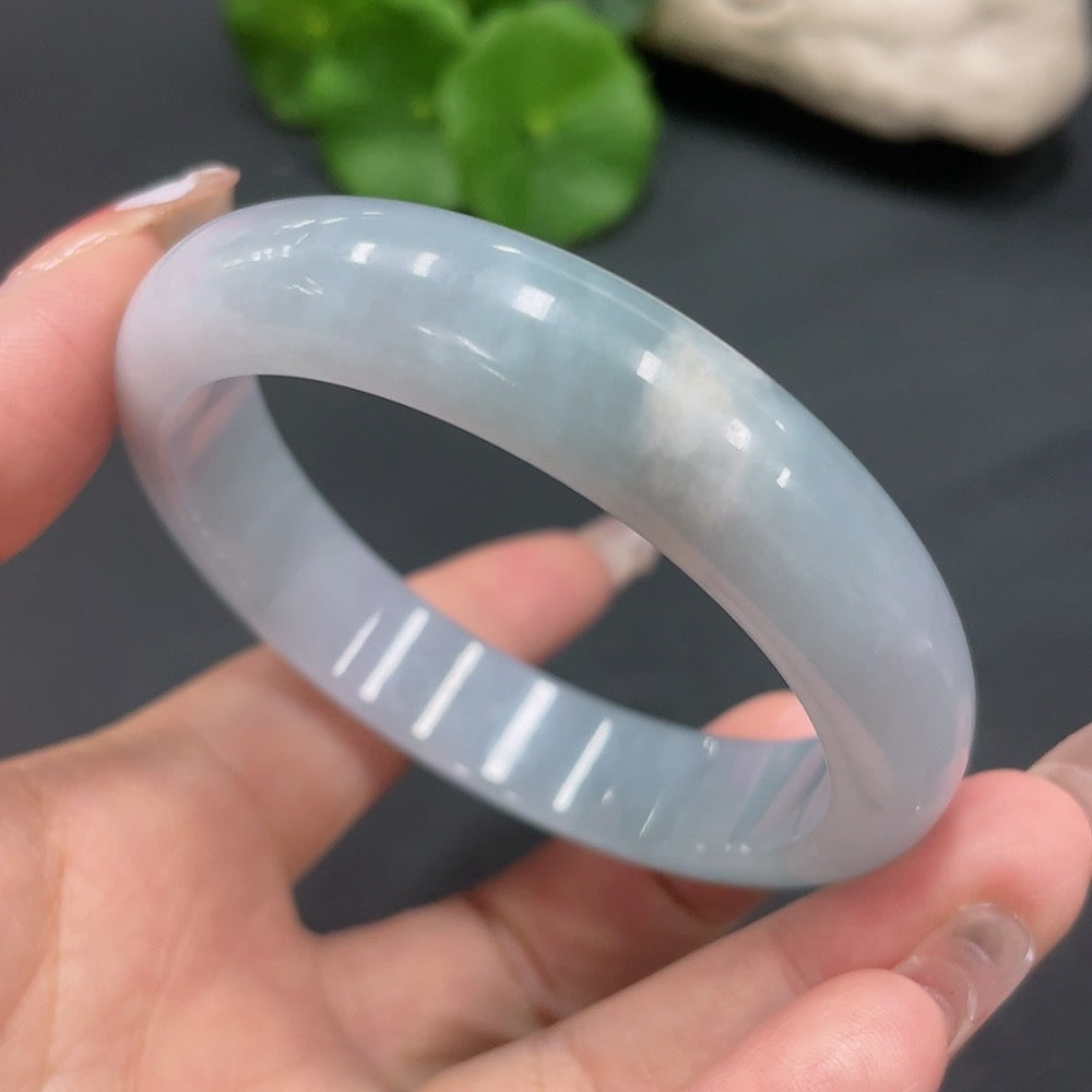 Huiliu Certified Jadeite Round Bangle with smooth polished surface, showcasing its elegant jade green color and rounded shape.