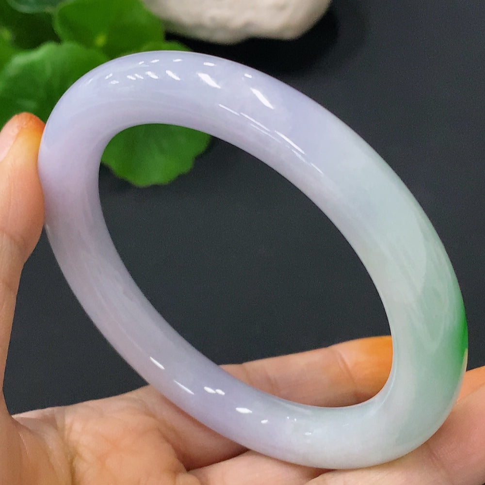 Huiliu Certified Jadeite round bangle, approximately 60mm, showcasing smooth, glossy green jade surface and craftsmanship.