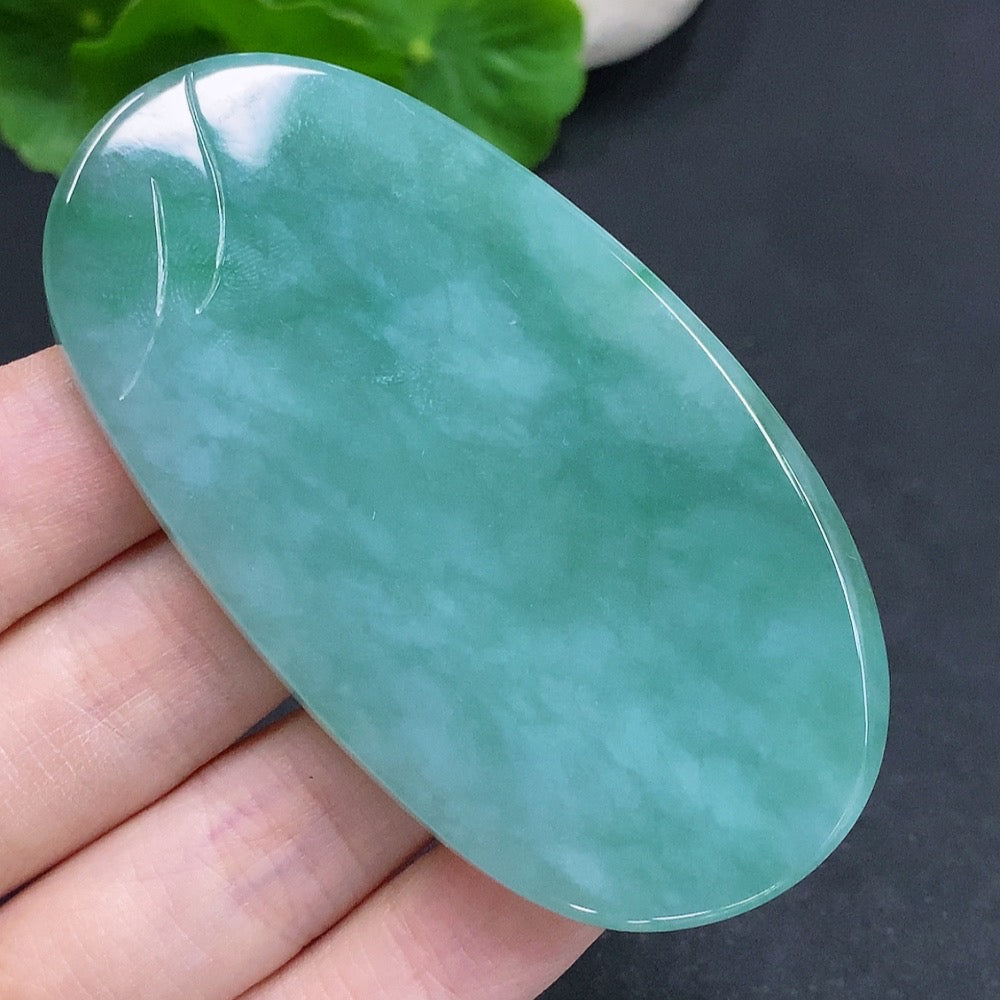Jadeite Guanyin pendant with formless design, crafted from jade, featuring a smooth, natural shape and intricate carved details.