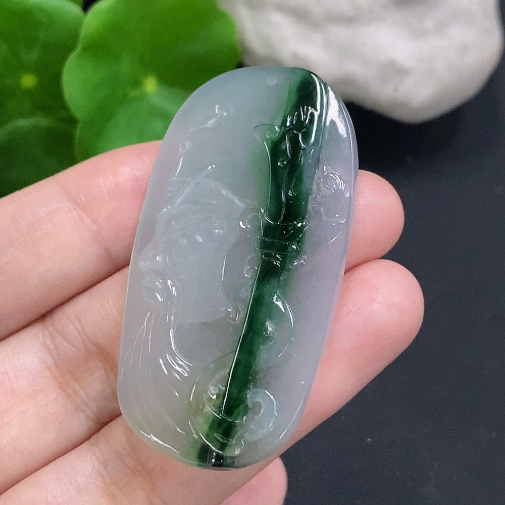 Jadeite Guan Gong pendant in green jade with detailed carved figure, hanging on a cord, crafted by HUILIU HQ.