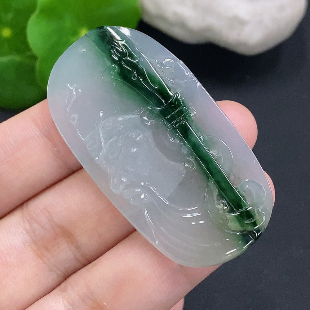 Jadeite Guan Gong pendant in green jade, showcasing intricate carving and smooth polished surface from HUILIU HQ.