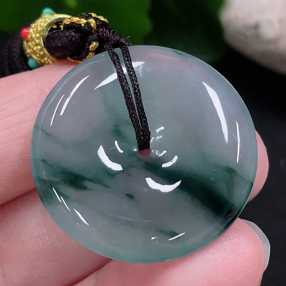 HUILIU HQ jadeite peace buckle pendant featuring a smooth, polished green jade stone with intricate carved details.