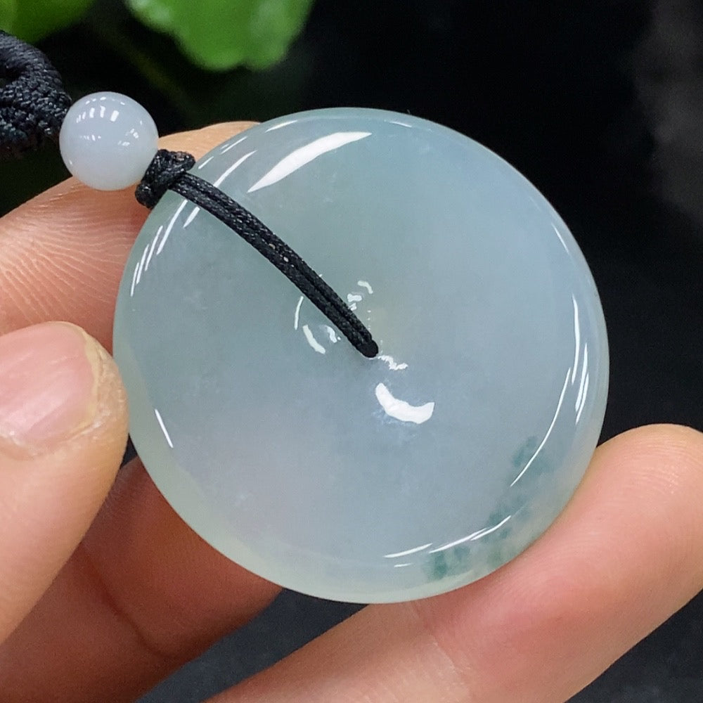 HUILIU HQ jadeite Peace pendant showing smooth, polished jadeite with carved peace symbol on a sleek cord.