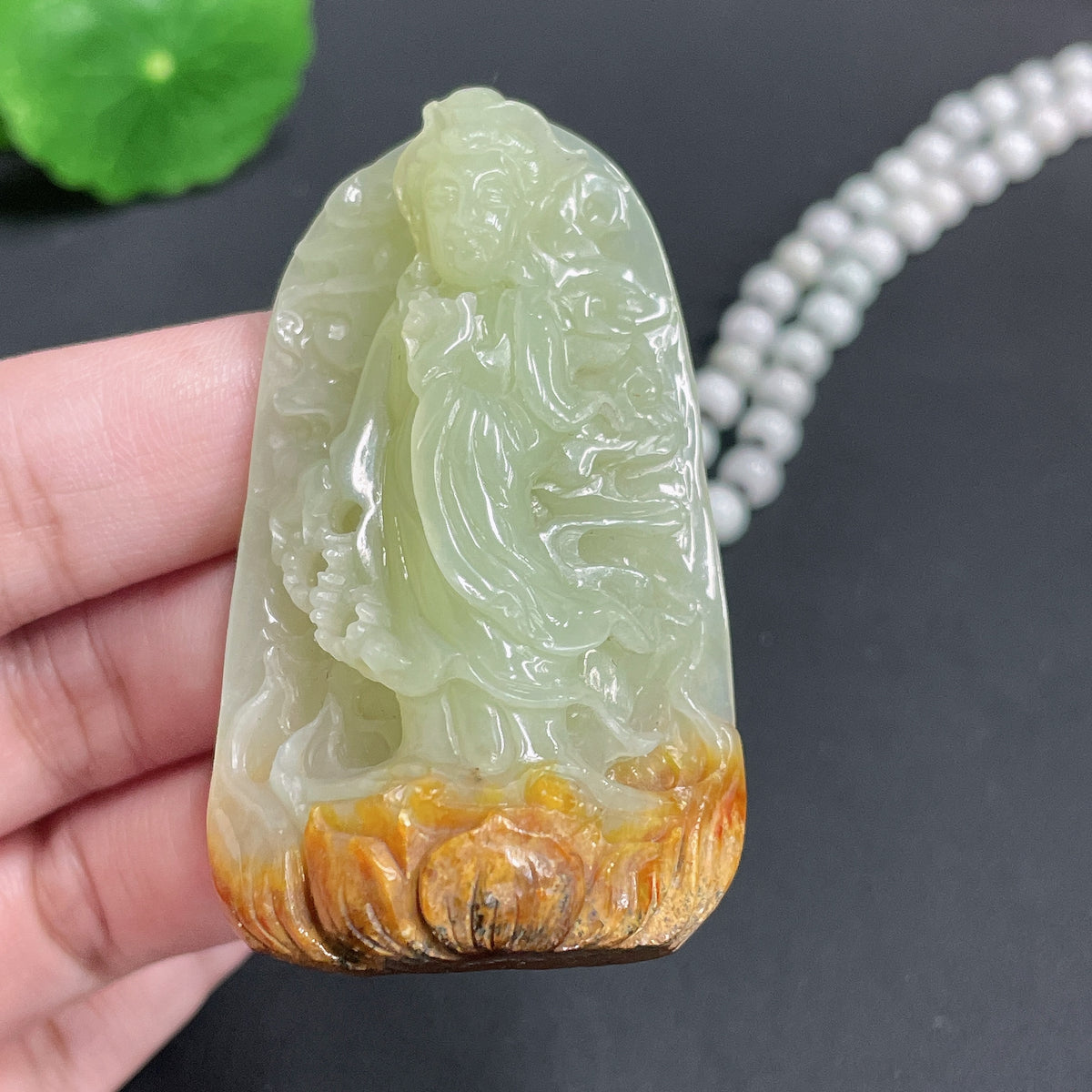 Huiliu Jade Khotan Guanyin pendant with chain, featuring intricate carved design on smooth jade, natural skin tone color.