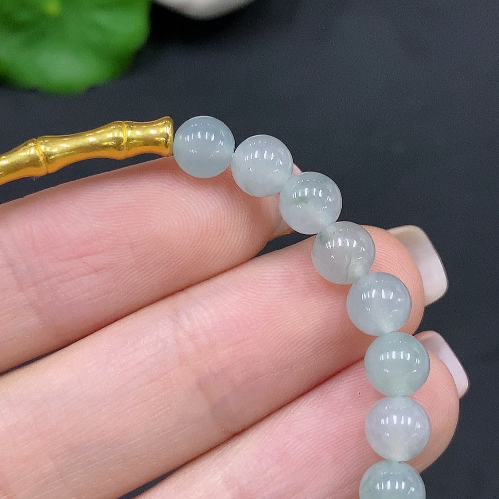 Natural Grade A jadeite bead bracelet with 5.8mm round beads from HUILIU HQ, featuring smooth, polished jade stones.