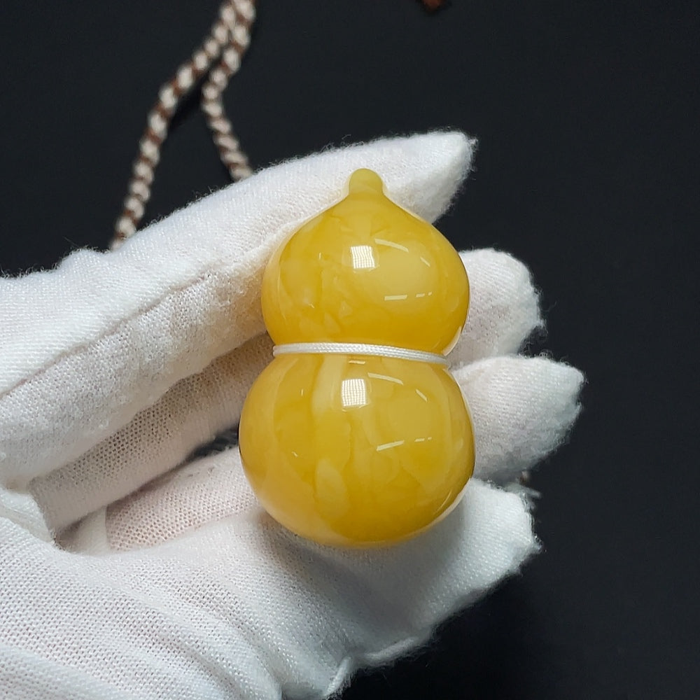 Amber beeswax pendant necklace by HKHQ featuring a natural amber pendant on a delicate chain.
