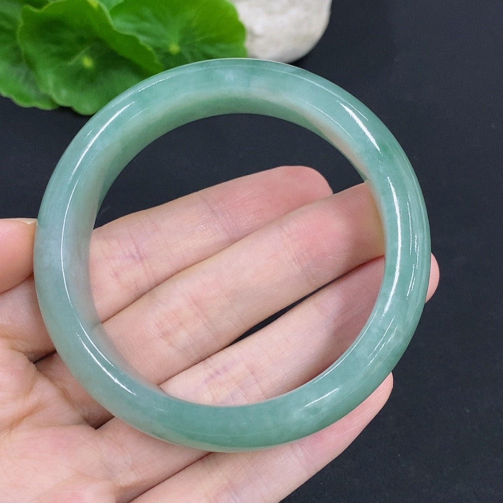 HKHQ jadeite round bangle, 65.9g, size 55.5, with smooth, polished surface and vibrant green color, showcasing elegant jewelry craftsmanship.