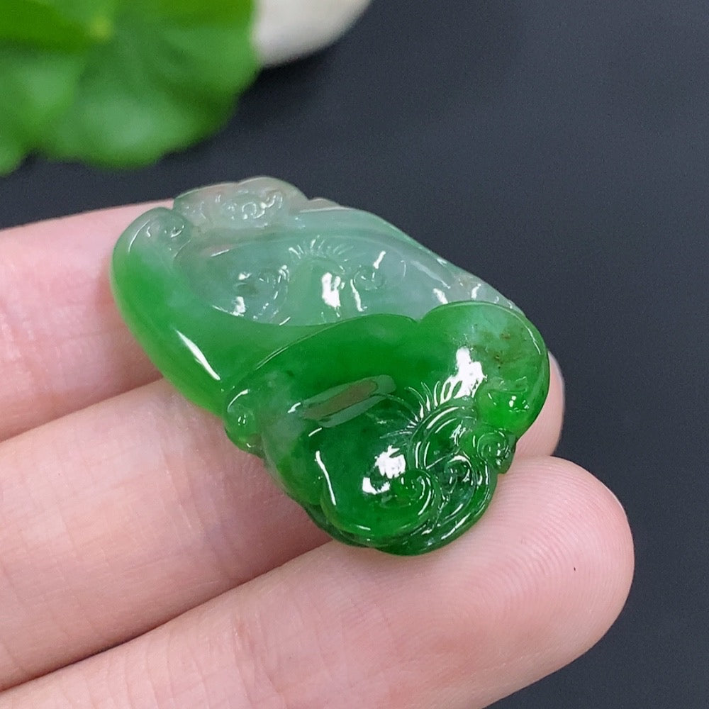 Jadeite Ruyi pendant with intricate carved design, weighing approximately 5.5g, from HKHQ, showcasing smooth green jade surface.