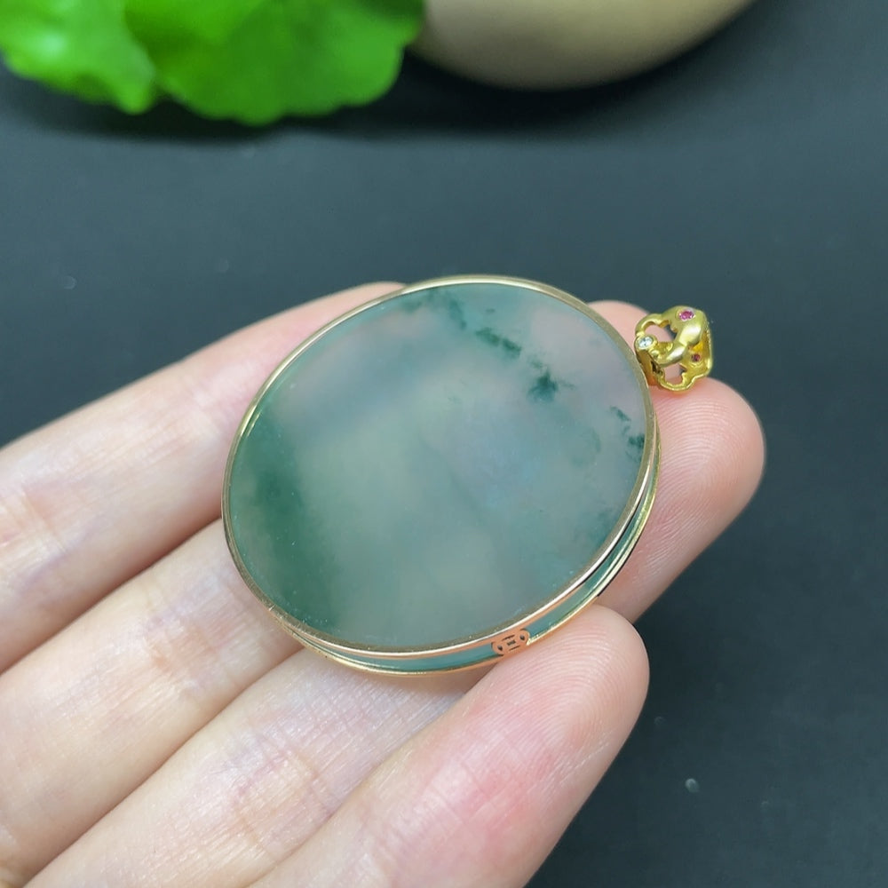 Jadeite round pendant with 18K gold setting and diamond accents, hanging on a delicate chain.