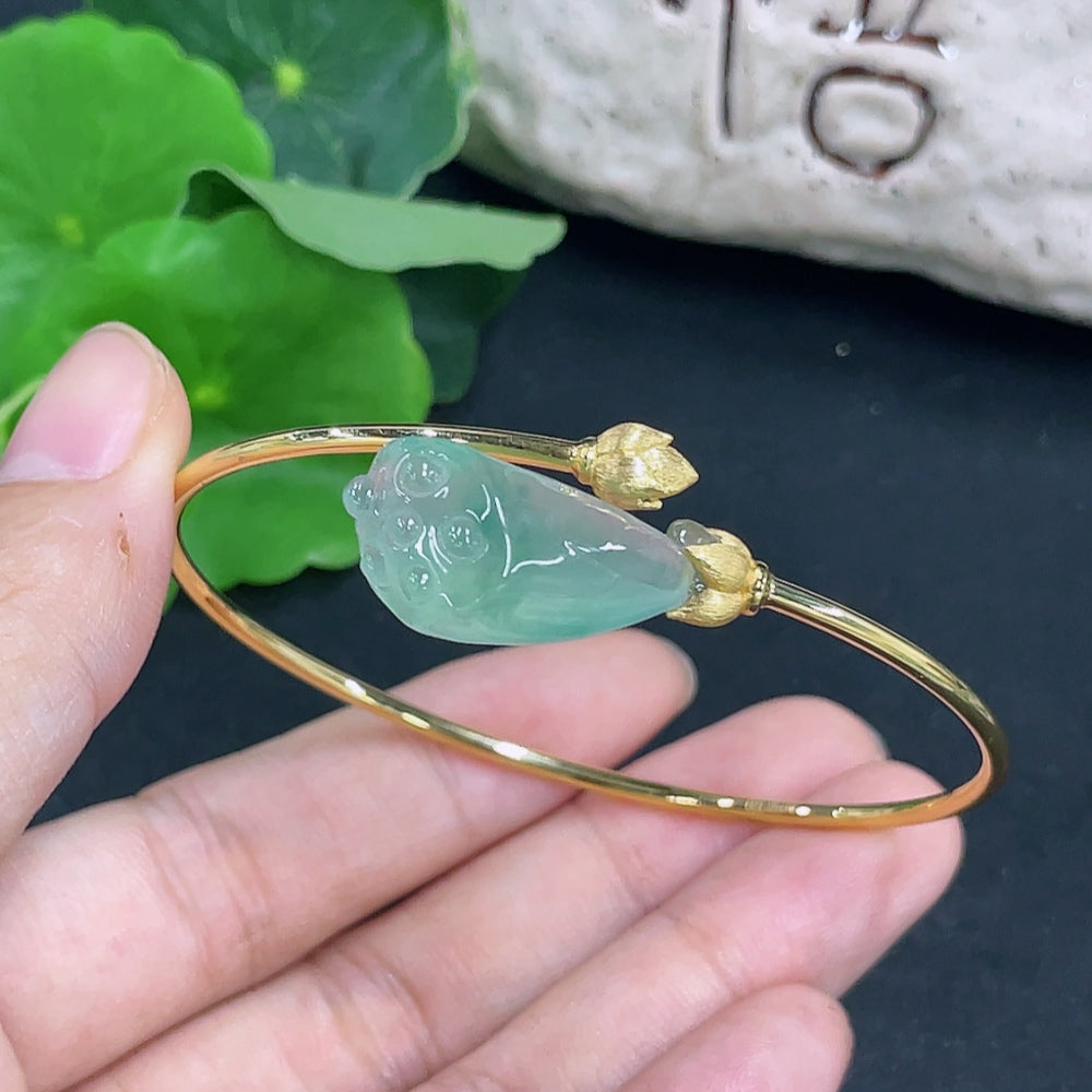 Elegant jadeite inlaid bracelet with 18K gold accents, featuring intricate design and polished finish, by HKHQ.