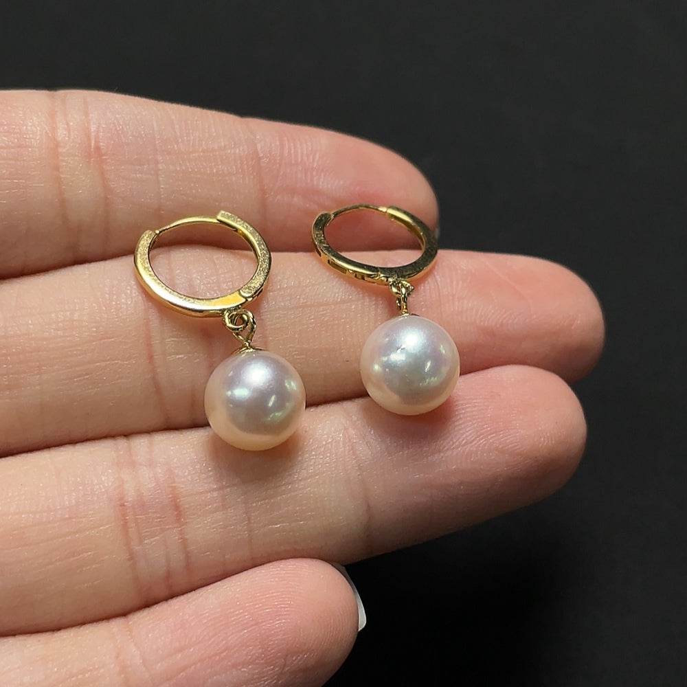 Saltwater pearl earrings with 18K gold setting from HKHQ, featuring elegant, round pearls on delicate gold hooks.
