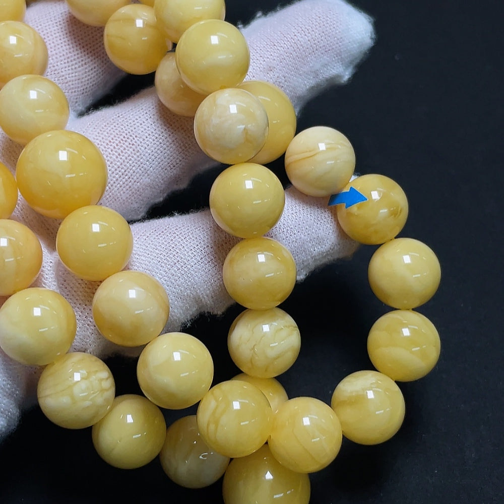 Amber beeswax bead strand with visible repairs, 11.4-14mm, weighing approx. 60.86g, from HKHQ.