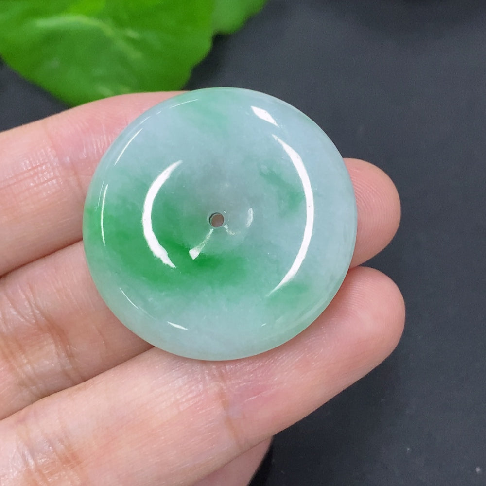 Jadeite safety buckle from HKHQ, approximately 11.7g, showcasing smooth, polished green jade with detailed craftsmanship.