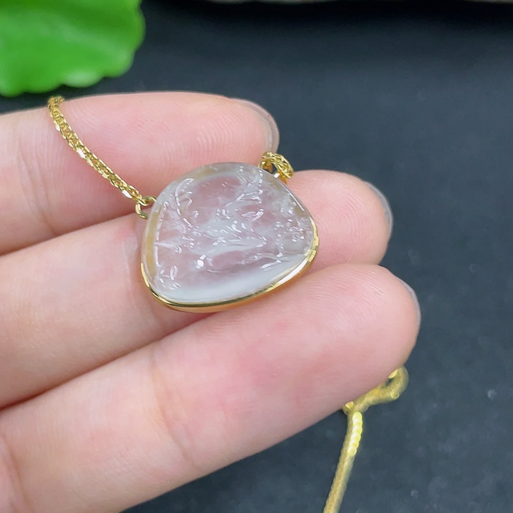 Elegant jadeite pendant with 18K gold setting on a chain, showcasing a smooth, polished green gemstone necklace.