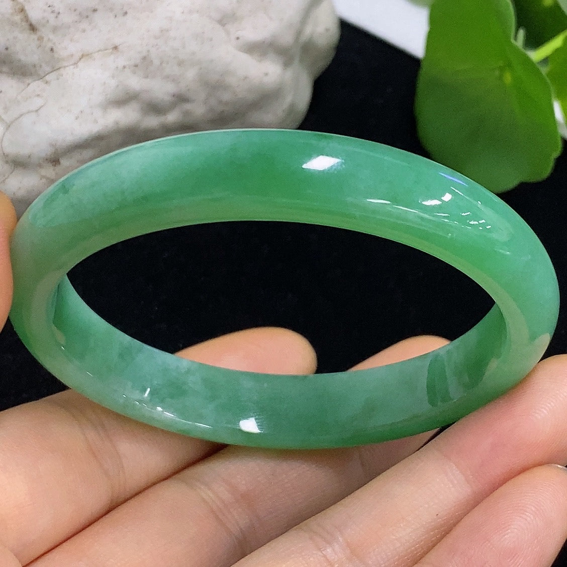 HKHQ jadeite oval bangle in size 56.2 with a weight of 38.3g, showcasing smooth, polished green jadeite bracelet design.