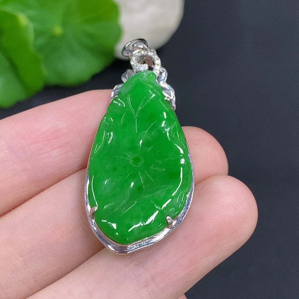 Jadeite lotus leaf pendant with 18K gold accents and diamond details, crafted by HKHQ, showcasing intricate design and elegant craftsmanship.