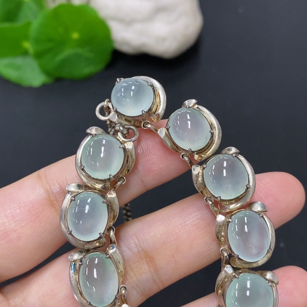 Smooth jadeite cabochon gemstone in a non-gold setting, weighing approximately 61.2g, from HKHQ.