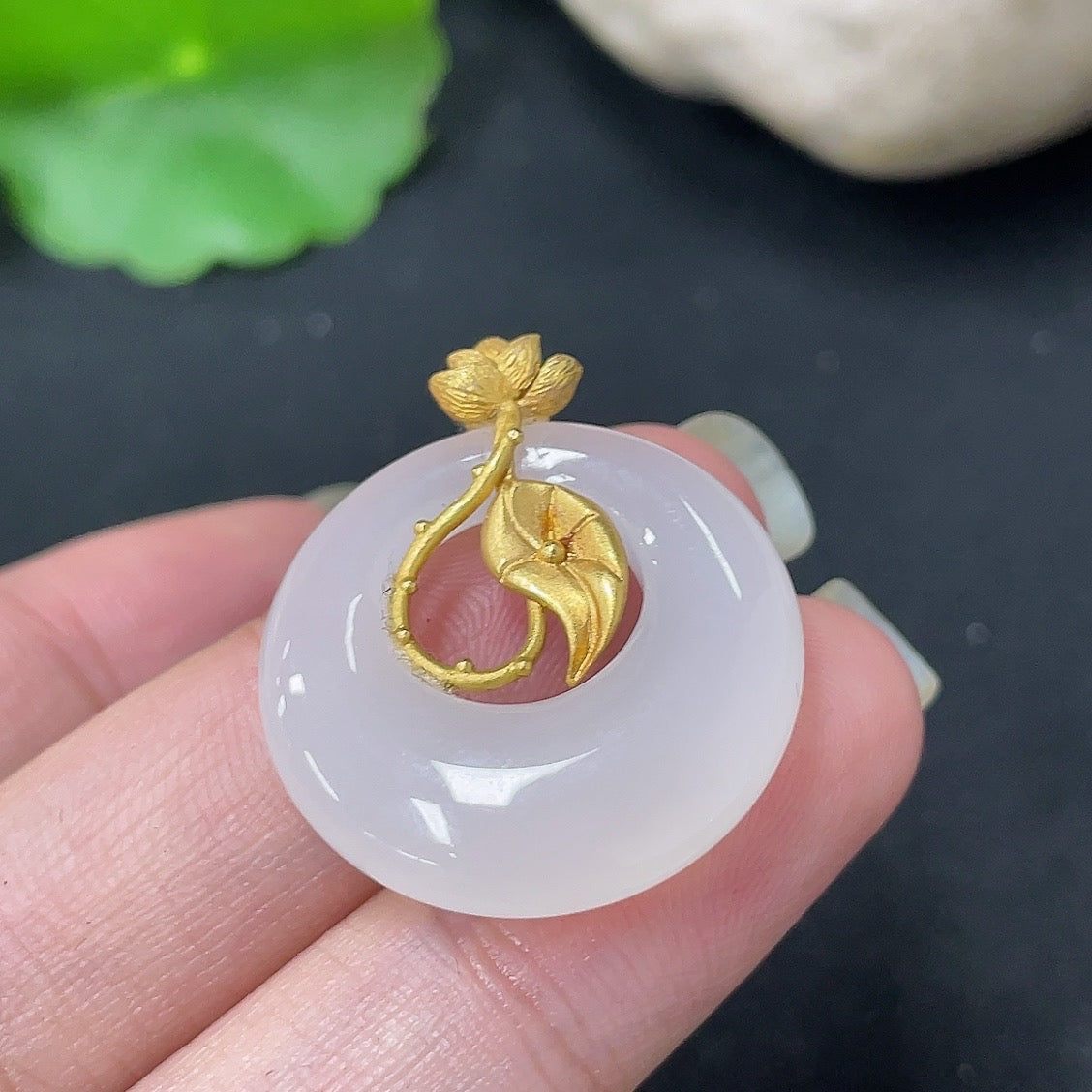 Hetian Jade inlaid pendant necklace with 18K gold setting, crafted by HKHQ, showcasing a detailed jade design on a chain.