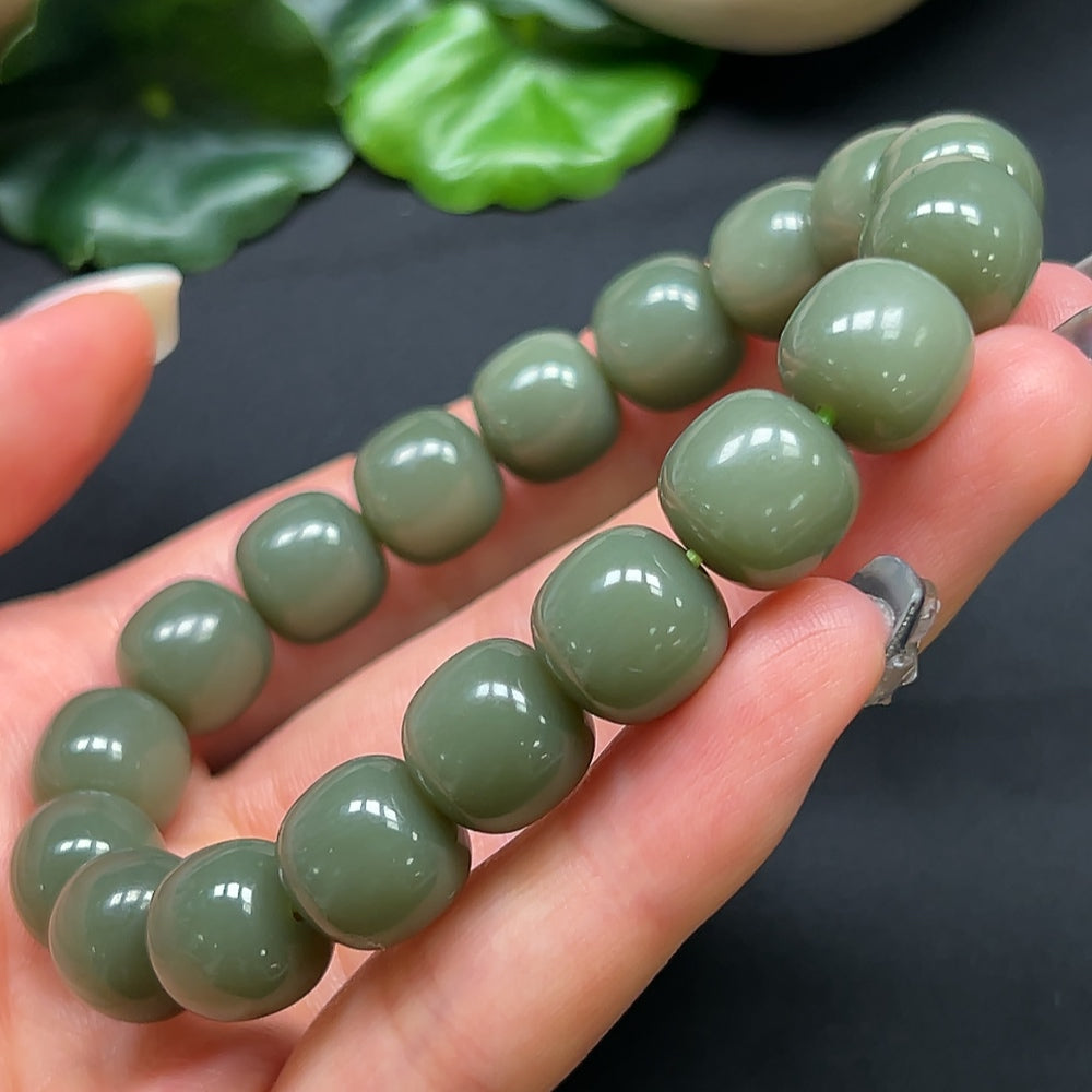 Hetian jade bracelet with 11.8mm beads, weighing approximately 49.28g, crafted by HKHQ, showcasing smooth, polished jade stones.