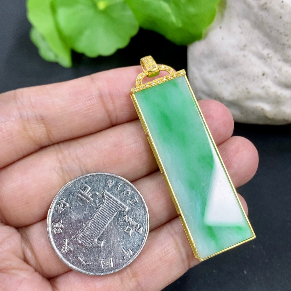 HKHQ jadeite pendant necklace with 18K gold setting and diamond accent, showcasing a smooth, polished jadeite stone on a delicate chain