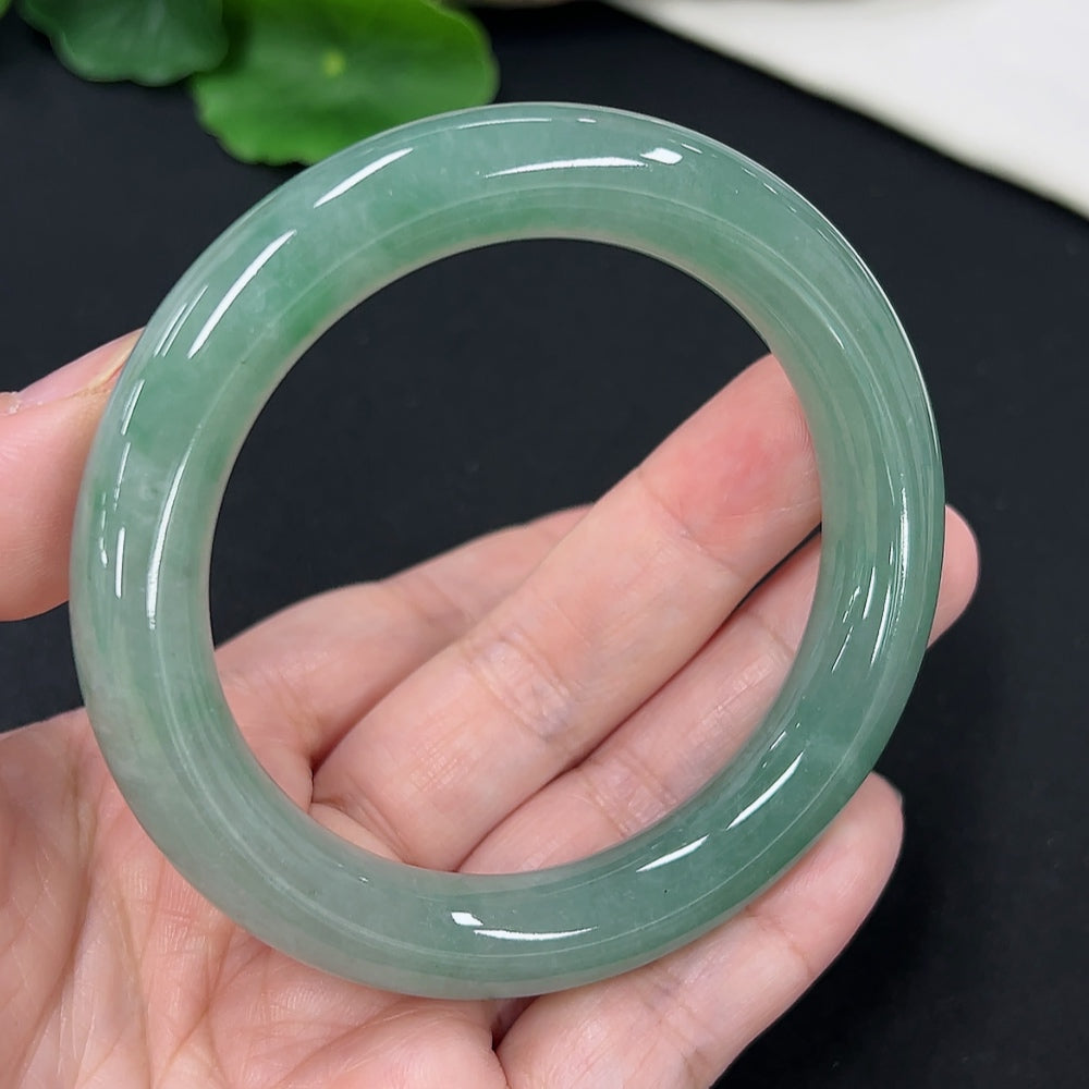 Jadeite round bangle in size 54.3 with a total weight of 58.4g, featuring smooth, polished jadeite surface and subtle green hues.