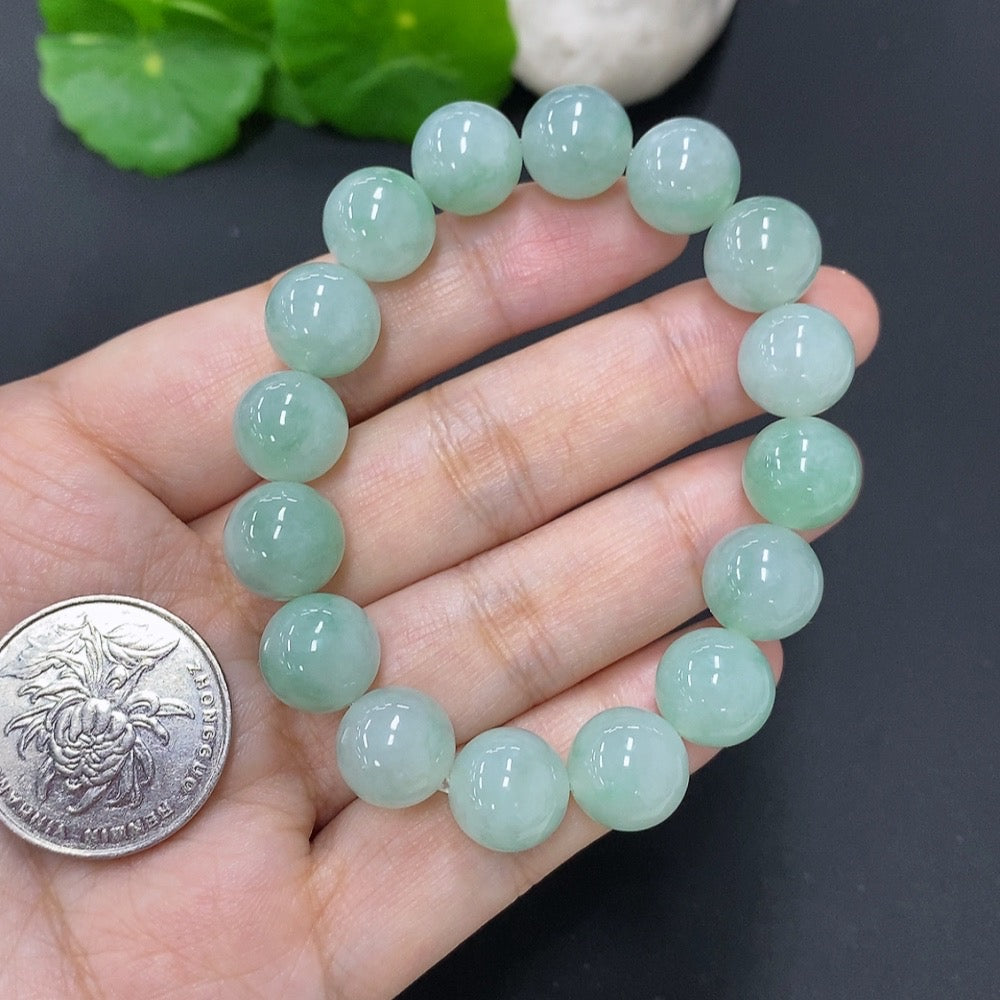 Jadeite bracelet from HKHQ, 11mm wide, with a total weight of approx. 39.8g, featuring smooth, polished jade stones.