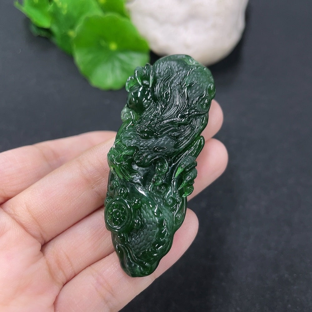 Jadeite pendant with carved dragon plaque, polished green jade, weighing approximately 21.95g, from HKHQ.